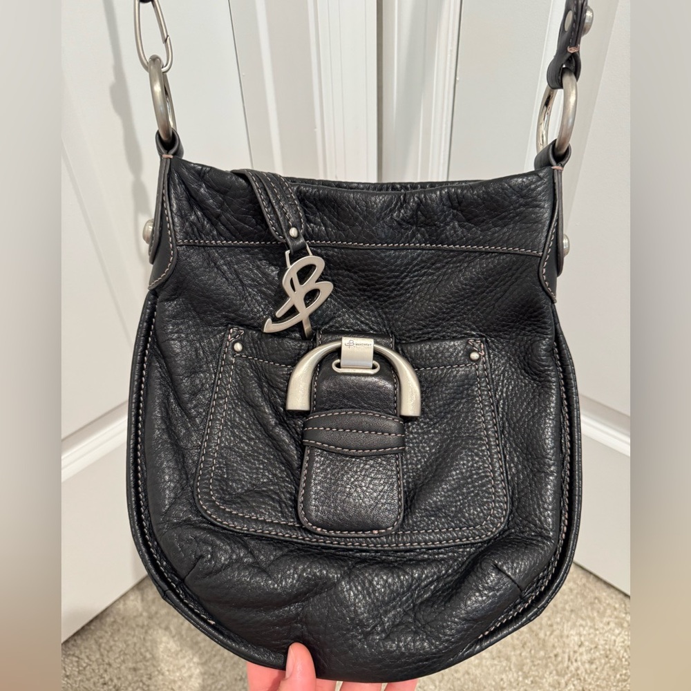 B. Makowsky Black Crossbody Bag with Saddle Shape and Adjustable Strap